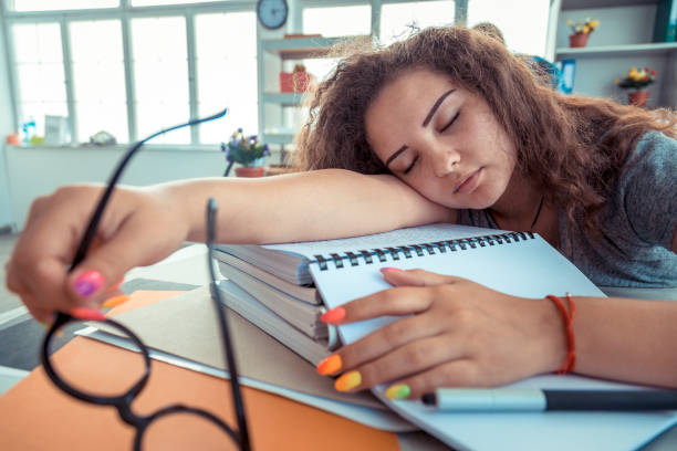 Tired assistant sleeping on a copy  of paper at the office