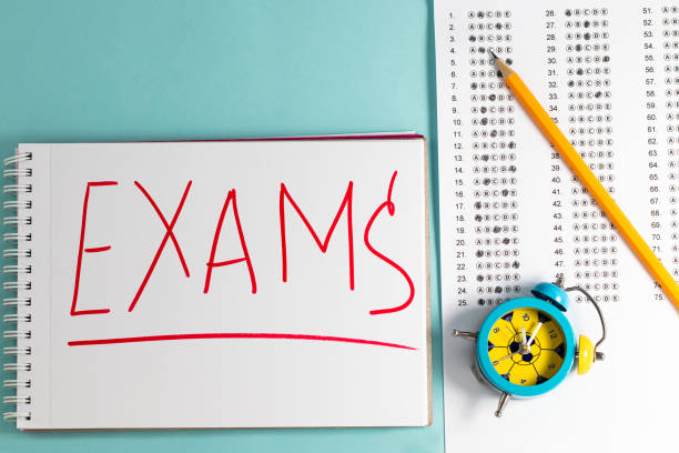 Take the exam, write the exam. Exam paper on blue background, top view copy space.