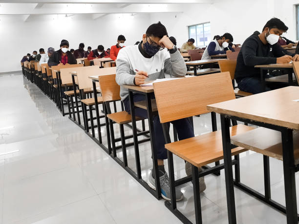 December 8, 2020.Lucknow Uttar Pradesh,India. West Bengal India. Medical students writing examination paper in mask maintaining social distancing at Radheshwam Medical College,Lucknow,