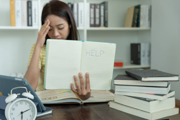 Asian student woman have anxiety because of exams, female prepare for test and learning lessons in the library. stress, despair, haste, misunderstanding reading, discouraged, expectation, knowledge