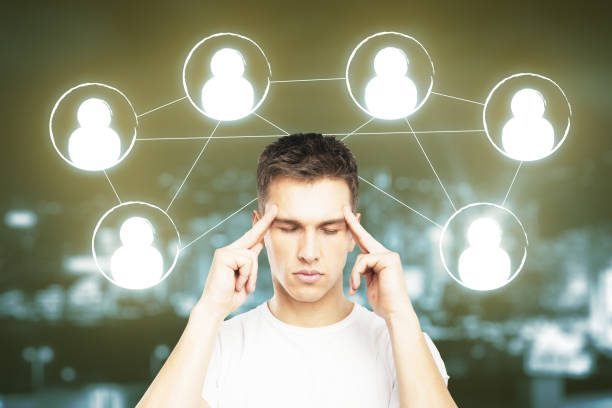 Thoughtful young man with HR icons on blurry night city background. Human resources concept
