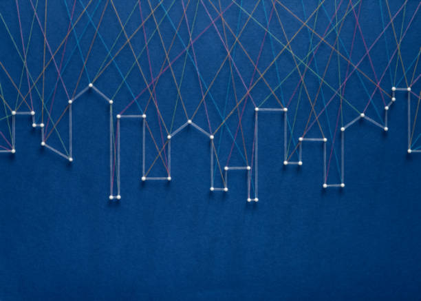 Urban connection concept. Network of pins and threads in the shape of a city skyline symbolising urban diversity and communication.