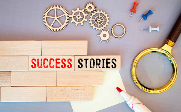 success stories typography - word abstract in vintage letterpress wood type on a digital tablet with a cup of coffee