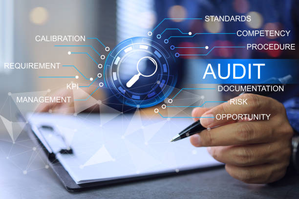 Auditor writing pen on clipboard white paper to audit company annual assessment every year ensure activities conform correct is not against law and plan to meet quality standards KPI and OKR target